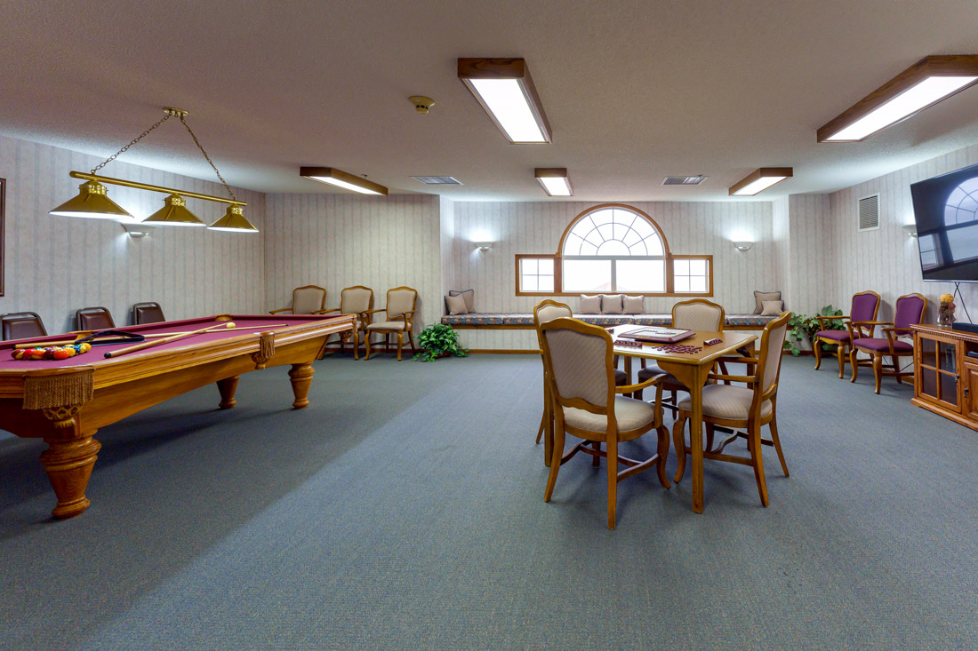 Lake Point Villa game room with a pool table, scrabble game, comfortable seating, and a TV.